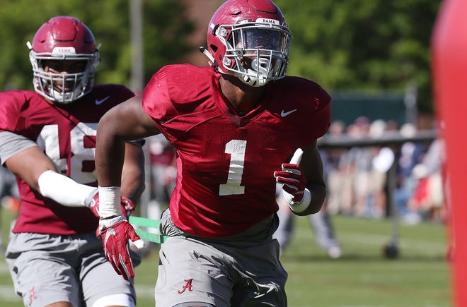 Alabama linebacker Ben Davis (1) runs against a resistance strap held by Alabama linebacker Mekhi Brown (48) during Alabama football practice at the Thomas-Drew practice fields at the University of Alabama in Tuscaloosa Friday, April 7, 2017. [Staff Photo/Erin Nelson]