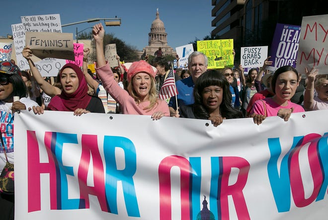 Former Texas State Sen. Wendy Davis, center, dressed in all pink, leads the Women's March in Austin, Texas on Jan. 21, 2017. Davis, who now runs the Austin-based women's advocacy group Deeds Not Words, recalls being touched "very inappropriately" by a newly elected House member at a 2009 social gathering for lawmakers. She never filed a complaint and wasn't even aware there was a process for doing so. Often the fear of coming forward and what the consequence of that will look like suppresses anyone from saying anything, she says. [Ralph Barrera/Austin American-Statesman via AP]