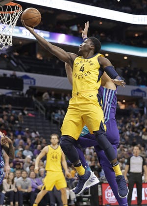 Indiana Pacers' Victor Oladipo (4) drives against the Charlotte Hornets during the second half of an NBA game on Sunday. [AP Photo/Chuck Burton]
