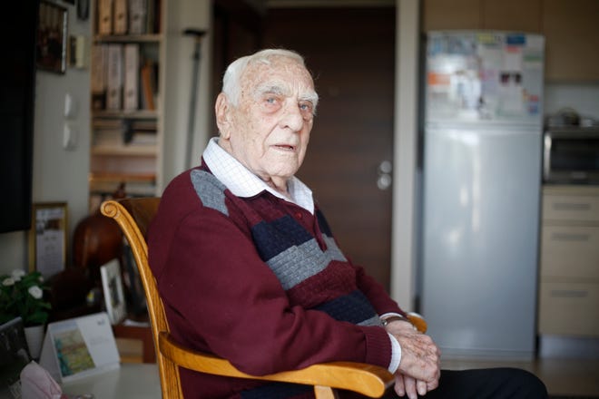 In this Tuesday, April 10, 2018 photo, Baruch Shub Holocaust survivor poses for a photo at his apartment in a senior citizens' home in Kfar Saba, Israel. While most of his fellow Jews were being killed or brutalized in Nazi death camps and ghettos, Shub and his friends were hiding out in the forests of the former Soviet Union, trying their best to undermine the Nazi war machine by derailing trains, burning bridges and sabotaging telephone and electricity lines. Israel marks its annual Holocaust memorial day this week, with a dwindling survivor population. (AP Photo/Ariel Schalit) ORG XMIT: ASC102