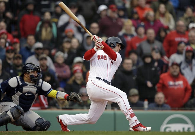 Andrew Benintendi strokes a double against the Rays on Sunday.