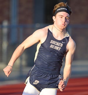 Sacred Heart High School sophomore Landon Power rounds the curve of the boys 200-meter dash Tuesday at the Salina South Invitational at Salina Stadium. [AARON ANDERS / SALINA JOURNAL]