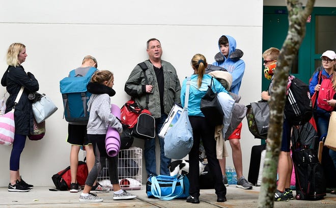 Evacuees from approaching Hurricane Irma, some with pets, arrive at Lakewood Ranch High School on Sept. 10, 2017. The campus served as one of 24 public schools in the county used as shelters during the storm. [HERALD-TRIBUNE STAFF PHOTO / THOMAS BENDER]