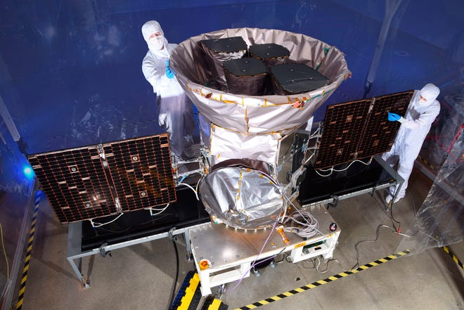 This undated photo made available by NASA shows technicians with the Transiting Exoplanet Survey Satellite (TESS). Scheduled for an April 2018 launch, the spacecraft will prowl for planets around the closest, brightest stars. These newfound worlds eventually will become prime targets for future telescopes looking to tease out any signs of life. (NASA via AP)