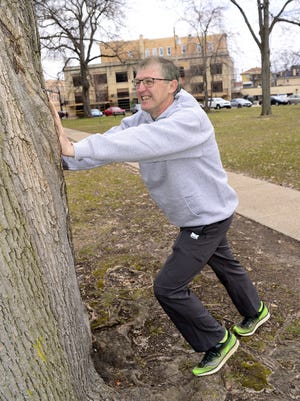 Herb Cratty, 54, of Ellwood City, is being inducted into the Pittsburgh Marathon Hall of Fame. He is pictured stretching in Irvine Park in Beaver, where he comes every Tuesday to run with a group associated with Lloyd's The Running Store. [Lucy Schaly/BCT staff]