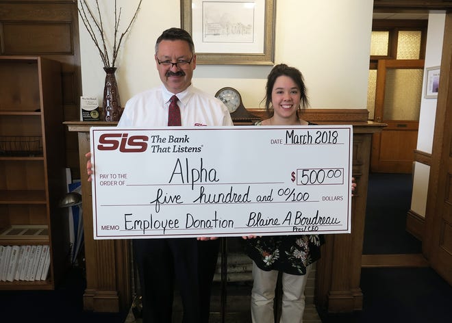 SIS Bank employee Sarah Corriveau (right) was selected as the most recent recipient for the Bank’s Employee Donation Program. President Blaine Boudreau (left) presents a check for $500 to Alpha, her organization of choice.

[Courtesy photo]