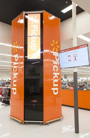 Walmart Pickup Towers allow customers to order items online and pick them up with a barcode scan sent to their smartphone. [WALMART PHOTO]