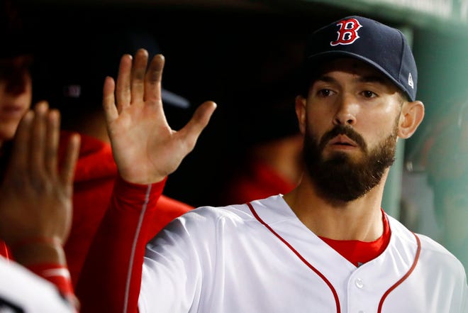 Boston Red Sox starting pitcher Rick Porcello is congratulated in the dugout after leaving the game the baseball game against the New York Yankees following the seventh inning at Fenway Park in Boston Thursday, April 12, 2018. (AP Photo/Winslow Townson)