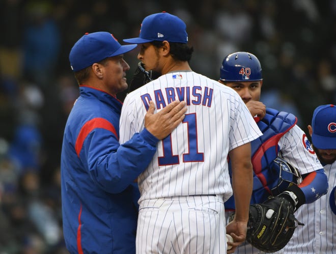 Chicago Cubs pitching coach Jim Hickey, left, talks with starting pitcher Yu Darvish as catcher Willson Contreras looks on after the Atlanta Braves scored during the fifth inning of Friday's game. [AP Photo/Matt Marton]