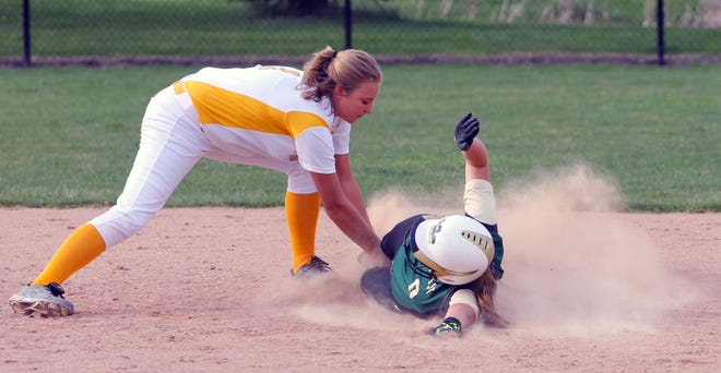 A Zeeland East player tags out a Zeeland West player in last year's rivalry doubleheader. [Sentinel file]