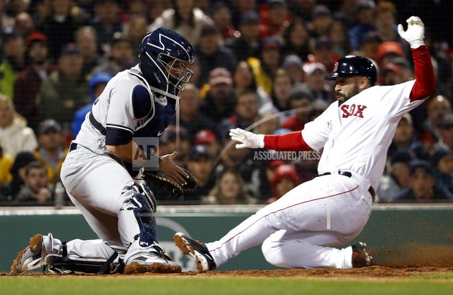 Boston Red Sox's Sandy Leon scores as Yankees catcher Gary Sanchez doesn't handle the throw during New York's loss on Thursday at Fenway Park in Boston. [The Associated Press]