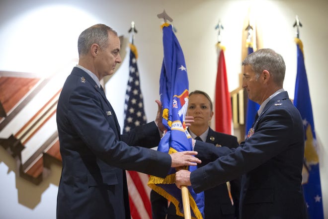 Lt. Gen. R. Scott Williams is handed the flag of the 601st AOC by Colonel John Ferry at the change of command ceremony at Tyndall Air Force Base on Friday. [JOSHUA BOUCHER/THE NEWS HERALD]