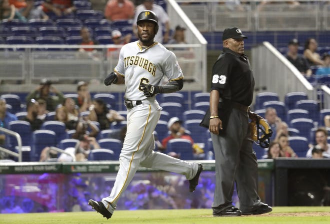 The Pirates' Starling Marte (6) scores on a single by Corey Dickerson during the ninth inning Saturda in Miami. [Lynne Sladky/The Associated Press]