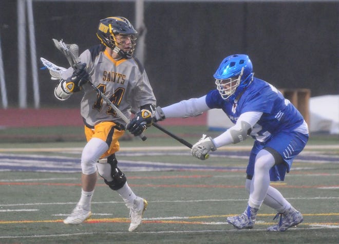 Siena Heights freshman Garnet Potter (14) attacks against 
Lawrence Tech defender Matthew Corse during Saturday's WHAC matchup.