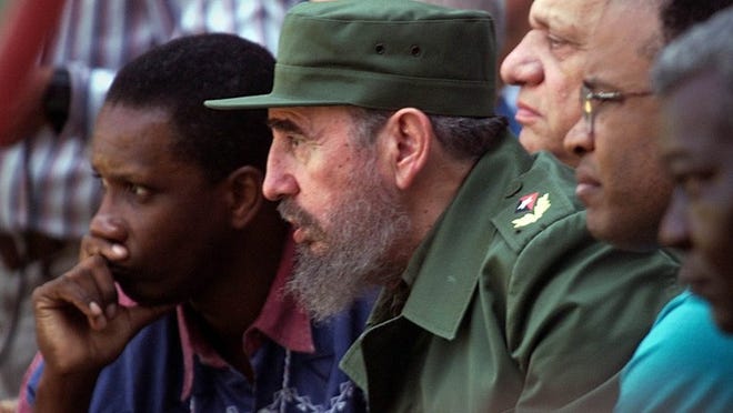 Cuban President Fidel Castro watches the Baltimore Orioles play the Cuban national team in 1999. The late Cuban leader is listed among the most influential in Florida’s history.