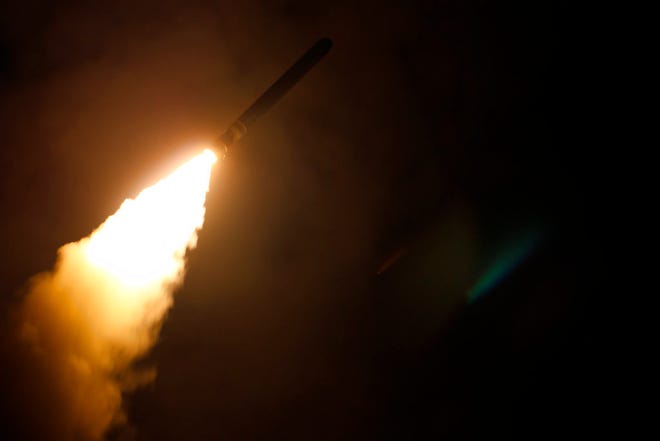 In this image provided by the U.S. Navy, the guided-missile cruiser Monterey fires a Tomahawk land attack missile Saturday as part of the military response to Syria's use of chemical weapons on April 7. [Lt. j.g. Matthew Daniels / U.S. Navy via AP]