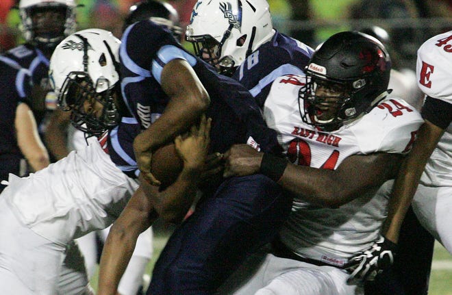 East's DeVontae Sims, shown tackling Guilford's Derick Lowery, was the NIC-10 defensive player of the year. Six years ago, East was one of the schools that might have benefitted most from NIC-10 expansion, but has gained almost 500 students since then and made the football playoffs this year for only the second time in 30 years. [RRSTAR.COM FILE PHOTO]