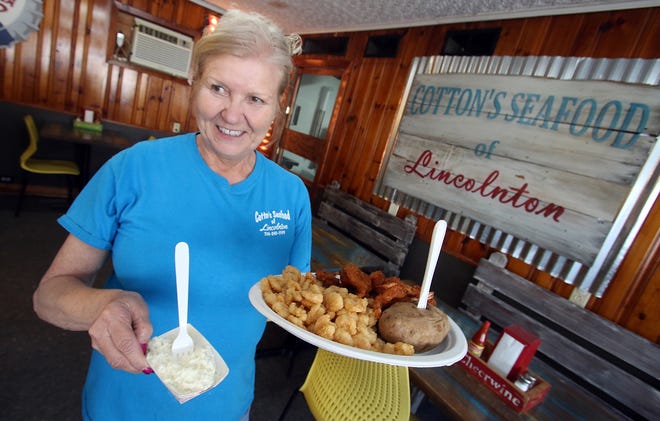 Kay Ferguson brings out a dinner seafood platter at Cotton's Seafood on Gastonia Highway. [Mike Hensdill/The Gaston Gazette]