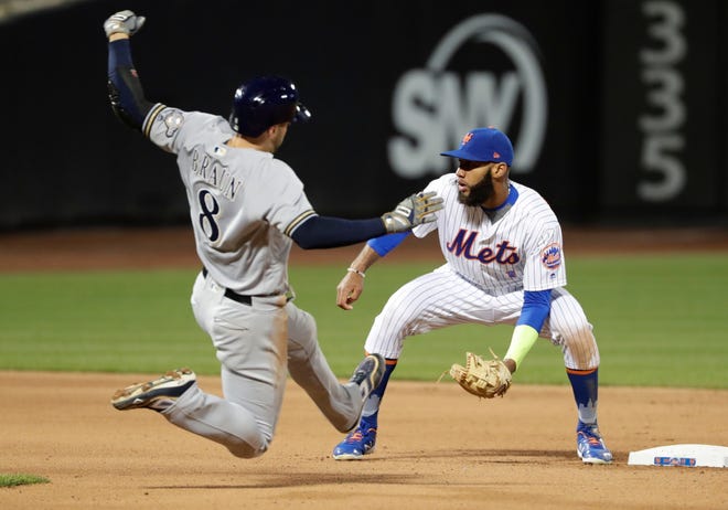 Milwaukee Brewers' Ryan Braun (8) slides past Mets shortstop Amed Rosario (1) to steal second base during host New York's 5-1 loss on Saturday. The defeat ended the Mets' nine-game winning streak. [The Associated Press]