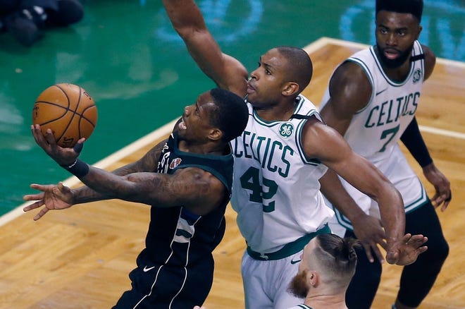 Milwaukee Bucks' Eric Bledsoe (6) goes up to shoot in front of Boston Celtics defender Al Horford (42) during the third quarter of Game 1 of their first-round playoff series in Boston on Sunday. [Photo by AP]