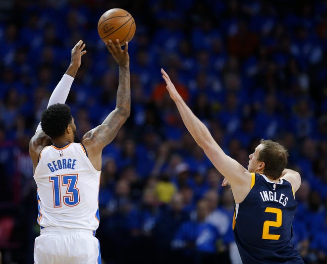 Oklahoma City's Paul George (13) shoots over Utah's Joe Ingles (2) during Game 1 in the first round of the NBA playoffs between the Oklahoma City Thunder and the Utah Jazz at the Chesapeake Energy Arena, Sunday, April 15, 2018. Photo by Sarah Phipps, The Oklahoman