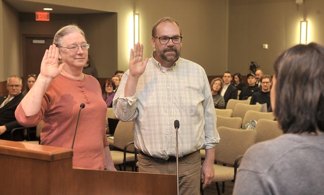 Columbia City Clerk Sheela Amin gives the oath of office to incumbent city councilman Michael Trapp, second ward and councilwoman Betsy Peters, sixth ward, Monday before the regular council meeting at City Hall. [Don Shrubshell/Tribune]
