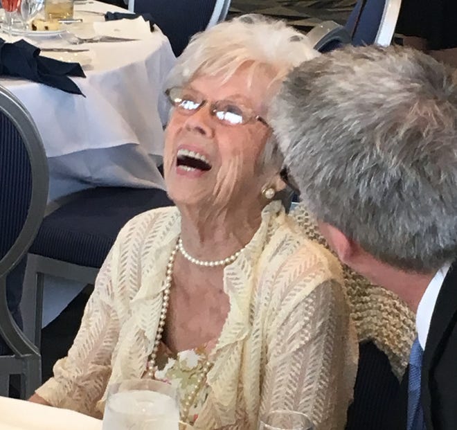 Anna Nelson of Millcreek Township shares a laugh with her son, Craig, at a 100th birthday party that family and friends threw for her at the Sheraton Erie Bayfront Hotel on Sunday afternoon. [TIM HAHN/ERIE TIMES-NEWS]