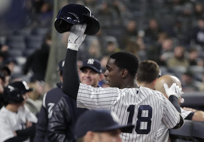 The Yankees' Didi Gregorius (18) raises his batting helmet to the crowd after hitting a solo home run, his second of the game, during Monday's rout of the Marlins in New York. [Julie Jacobson/AP]
