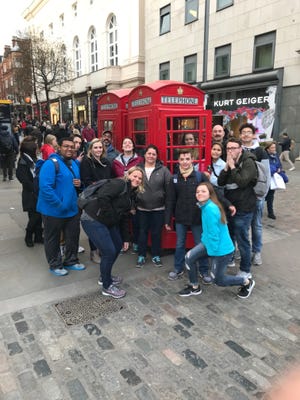 Salina students and family members posing with a London telephone booth: from left, Donivan Thomas, Mark Luber, John Luber, Aimee Maier, Emily Byrd, Christina Byrd, Jody Nutter, Lucas Nutter, Mackenzie Nutter, Jacque Holdren, Kim Tran, Andrew Hodge, Larry Nutter and Cooper Brown. [COURTESY PHOTO]