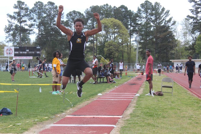 Jack Britt's Tyler Williams leaps during the triple jump event Saturday at the Carver Classic track and field meet at Reid Ross Classical School. [Sonny Jones/The Fayetteville Observer]