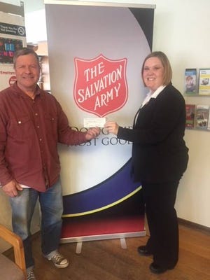 Club 76 President, John Dawkins, left, presents a $200 check to Captain Pam Kasten of The Salvation Army. Contributed photo