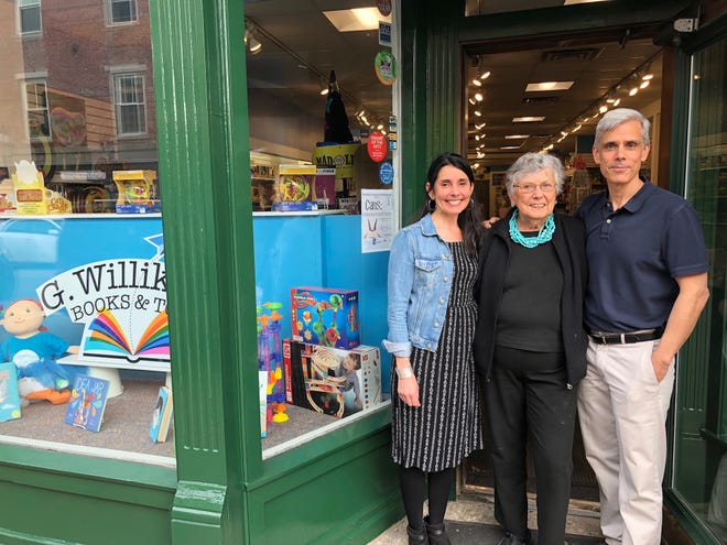From left, Jody, Jill and Bob Breneman stand in the doorway of G.Willikers! Their Market Square book and toy store celebrates its 40th birthday this weekend with special events, activities and surprises. [Courtesy photo]