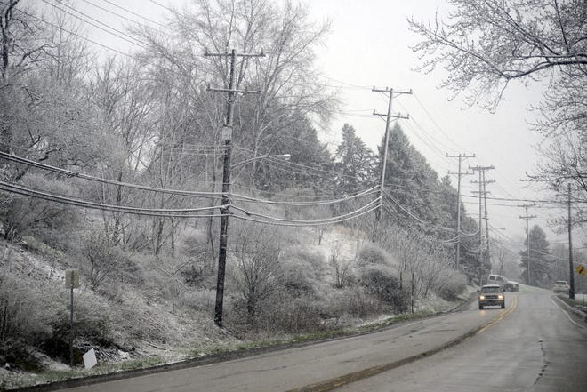 Drivers pass snow-covered trees Thursday morning as they make their way along Brodhead Road in Center Township. [Lucy Schaly/BCT staff]