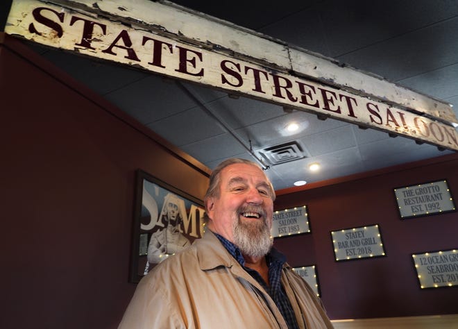 Eli Sokorelis, inside the new Statey Bar and Grill on State Street in Portsmouth, displays the old State Street Saloon sign that was saved from the April 10, 2017 fire that destroyed the saloon. Sokorelis plans to open his new pub Friday, April 20. [Rich Beauchesne/Seacoastonline]