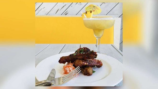 Breeze Ocean Kitchen's barbecue duck wings with sweet chili sauce and its pineapple margarita. Courtesy of Eau Palm Beach Resort.