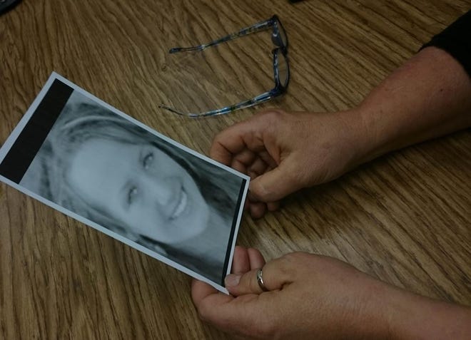 Theresa Findelsen holds a black and white photo of her daughter, Caroline, who struck and killed in a hit-and-run incident on U.S. 17 in Holly Ridge on Dec. 31, 2009. N.C. State Highway Patrol have few clues but several motorists saw the 18-year-old walking southbound in the northbound lanes minutes before she was struck. [Mike McHugh / The Daily News]