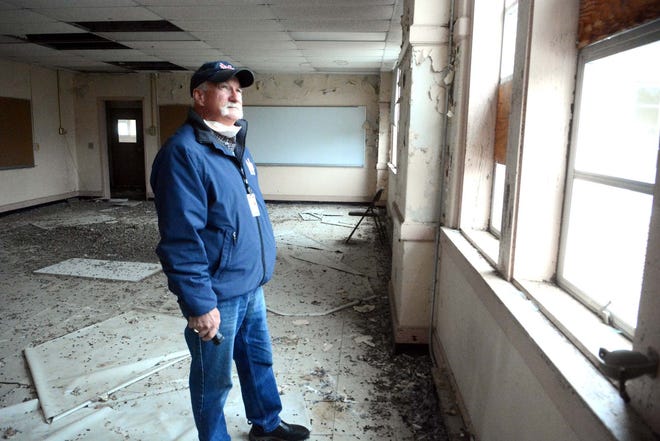 Paul Yellen, Plainfield fire marshal, looks at broken windows and other debris on the second floor of the former Plainfield High School annex Thursday. See videos and more photos at NorwichBulletin.com. [John Shishmanian/ NorwichBulletin.com]