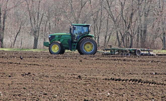 A South Kingstown farmer gets his field ready on Friday for planting. [The Providence Journal / Steve Szydlowski]