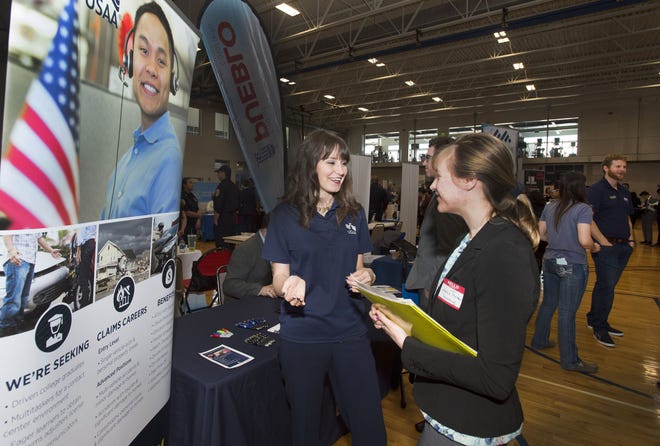 CHIEFTAIN PHOTO/CHRIS McLEAN USAA Financial Services representative Emily Kutil (left) visits with student Jeannie Thurston at the spring job fair March 6 at Colorado State University-Pueblo.