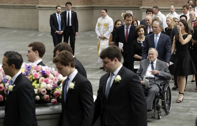 Former President George H.W. Bush and George W. Bush, followed by former first lady Laura Bush, follow as pallbearers carry the casket of former first lady Barbara Bush after a funeral service at St. Martin's Episcopal Church on Saturday in Houston. [AP Photo / Evan Vucci]