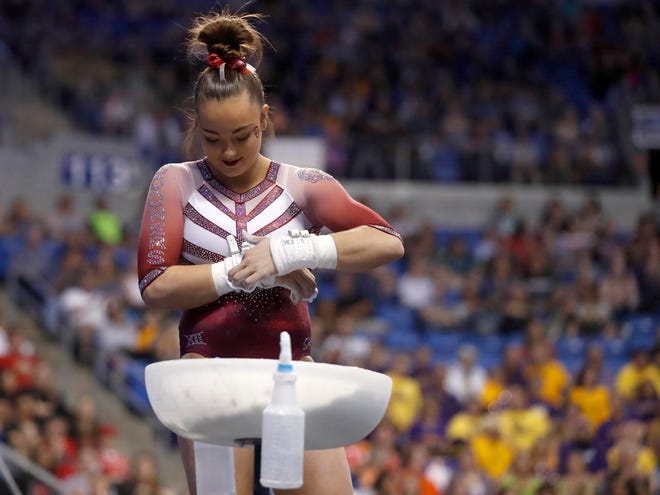 Oklahoma's Maggie Nichols prepares to compete on the uneven parallel bars during the NCAA college women's gymnastics championships Saturday, April 15, 2017, in St. Louis. (AP Photo/Jeff Roberson)