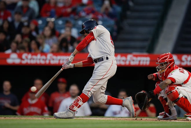 The Red Sox' Mookie Betts hits a home run against the Angels last Tuesday. Like so many of his teammates, Betts has been more aggressive at the plate this season and it's paying off.