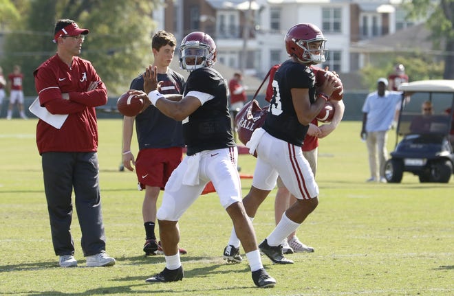 Alabama quarterbacks Jalen Hurts (2) and Tua Tagovailoa (8) throw passes as quarterbacks coach Dan Enos observes during the practice on Tuesday, April 3. Tagovailoa has not participated fully in spring drills after injuring his hand. [Photo/Jake Arthur]