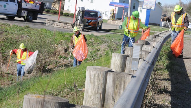 Ohio Department of Transportation District 5 workers, from left, Stacy Babcock, Austin Nichols, Gary Castello and Dave Carr, pick up litter along Route 40 west of Cambridge Friday morning in preparation of Earth Day.