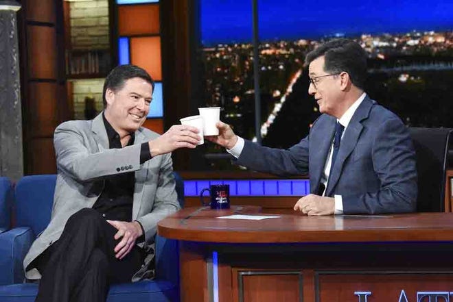 This image released by CBS shows former FBI Director James Comey, left, with host Stephen Colbert on "The Late Show with Stephen Colbert," Tuesday, April 17 in New York. [ SCOTT KOWALCHYK / AP ]