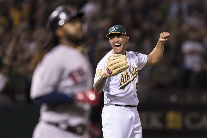 Oakland Athletics starting pitcher Sean Manaea celebrates his no-hitter against the Boston Red Sox in Oakland, Calif., late Saturday night. Boston's Hanley Ramirez, foreground, grounded into a force out to end the game. (AP Photo/John Hefti)