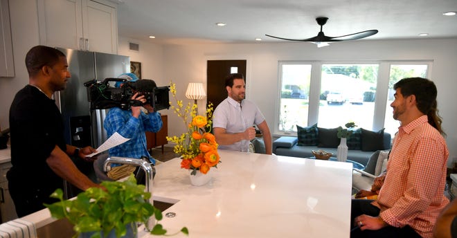 The camera crew is filming in the glamorously renovated kitchen of a 1956 house on Webber Street that is destined for Buyers Bootcamp on the DIY Network. Host (and investor) Scott McGillivray, center, chats with homeowners Katie Marie and David Hughes. [Herald-Tribune staff photo / Mike Lang]