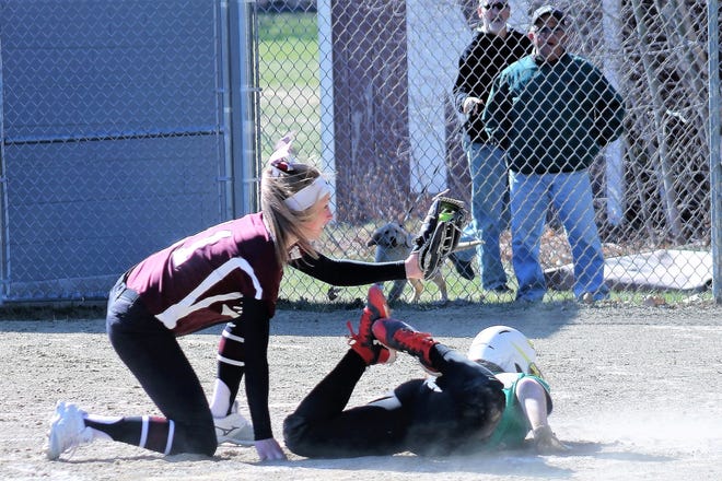 Noble pitcher Raegan Kelly, left, gets the out at the plate as Massabesic's Grace Tutt tries to score on a wild pitch during Class A South action Monday in North Berwick, Maine. [Al Pike/fosters.com]
