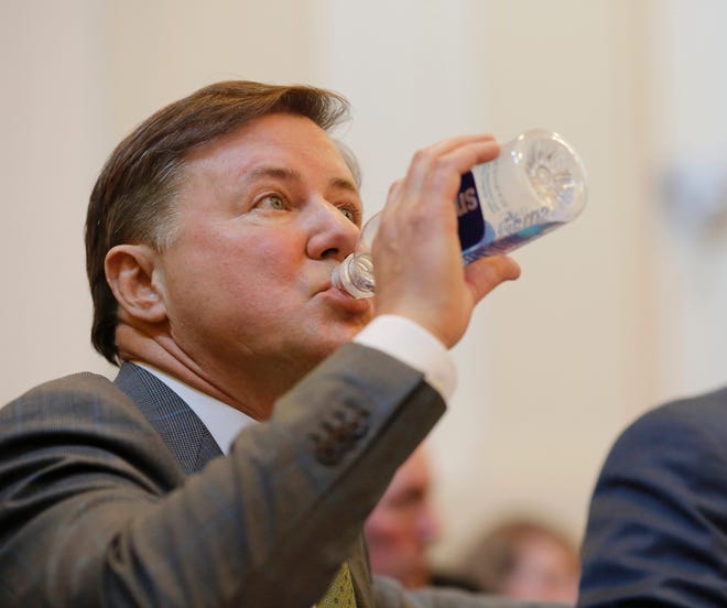 Challenger Gentner Drummond drinks water during the hearing. Oklahoma Attorney General Mike Hunter can remain on the ballot after the Oklahoma Election Board voted 3-0 on Monday, April 23, 2018, to deny a challenge to his candidacy on residency grounds. Hunter, a Republican, testified he always kept Oklahoma as his permanent home even though he lived in Virginia for years while working in Washington, D.C. for two trade organizations.
The hearing, on the second floor of the state Capitol, lasted more than two hours and included evidence about Hunter's ties to Oklahoma while he lived outside the state's borders. Making the challenge was a GOP rival, Gentner Drummond.

The Tulsa attorney said afterward he is considering whether to appeal to the Oklahoma Supreme Court. Photo by Jim Beckel, The Oklahoman