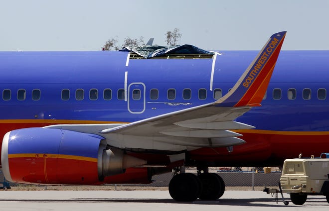 FILE - In this April 4, 2011 file photo, a Southwest Airlines plane sits in a remote area of the Yuma International Airport, after the plane had a section of fuselage tear from the plane during a flight in Yuma, Ariz. Over the years, the Dallas-based carrier has paid millions of dollars to settle safety violations, including multiple fines for flying planes that didn’t have required repairs. Twice in the last nine years, the roofs have peeled off Southwest planes during flight. (AP Photo/Ross D. Franklin, File)